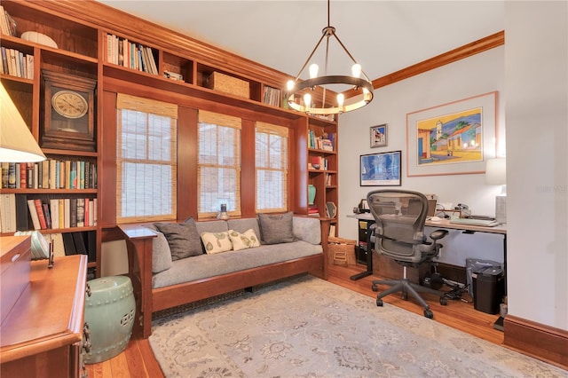 home office with ornamental molding, a notable chandelier, and wood finished floors