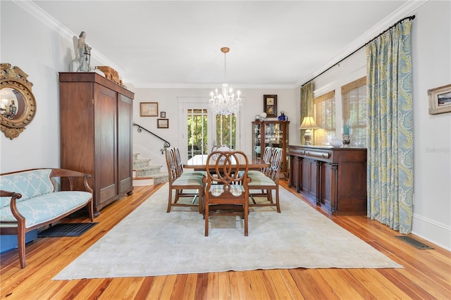 dining area with a chandelier and light wood-style floors
