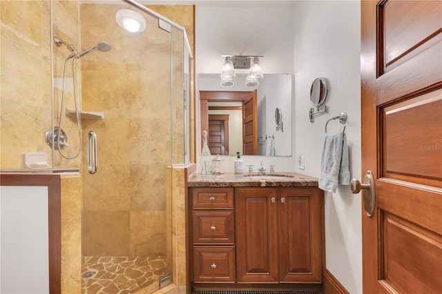 bathroom featuring a stall shower and vanity