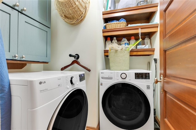 clothes washing area with washer and dryer and cabinet space
