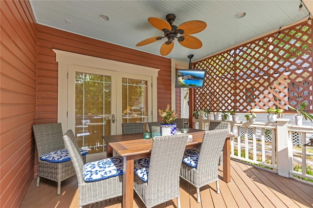 wooden terrace featuring outdoor dining space and ceiling fan