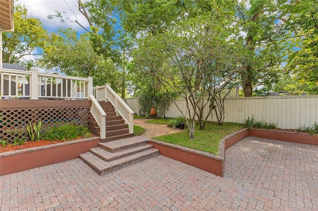 view of home's community featuring a deck, stairs, a fenced backyard, and a patio area