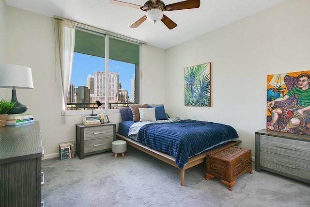 322 E Central Blvd Unit 1008, Orlando, FL 32801 - carpeted bedroom featuring a view of city, a ceiling fan, and baseboards