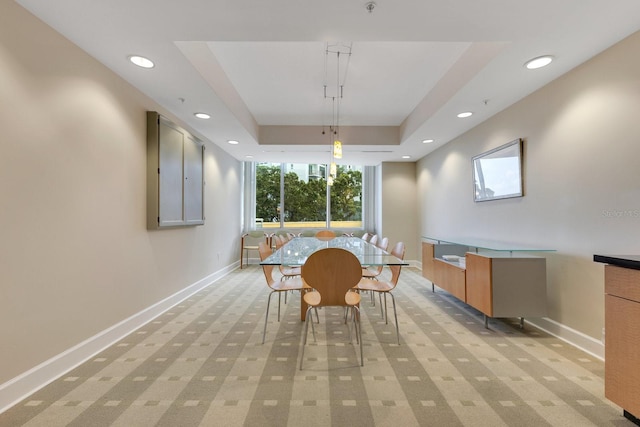 322 E Central Blvd Unit 1008, Orlando, FL 32801 - dining room featuring light colored carpet, recessed lighting, baseboards, and a tray ceiling