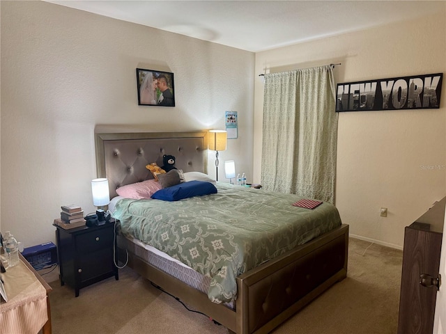 carpeted bedroom featuring baseboards