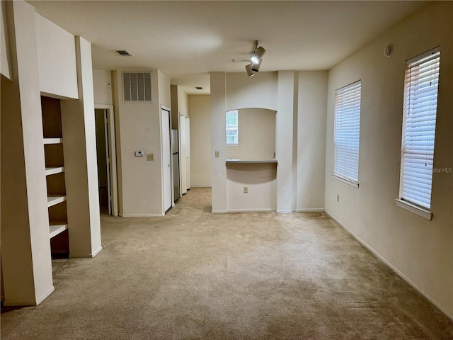 107 Vista Verdi Cir Unit 121, Lake Mary, FL 32746 - unfurnished living room featuring light colored carpet and arched walkways