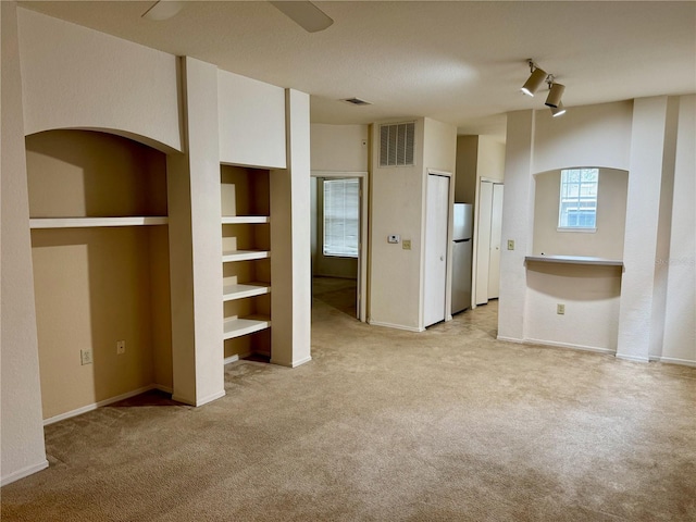 107 Vista Verdi Cir Unit 121, Lake Mary, FL 32746 - unfurnished bedroom featuring freestanding refrigerator, light colored carpet, two closets, and a ceiling fan