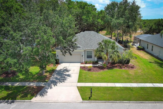 3835 Rock Hill Loop, Apopka, FL 32712 - view of front facade with driveway, a shingled roof, a garage, and a front yard