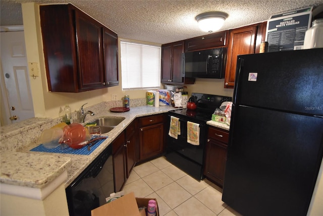 kitchen featuring a textured ceiling, light tile patterned floors, a sink, and black appliances