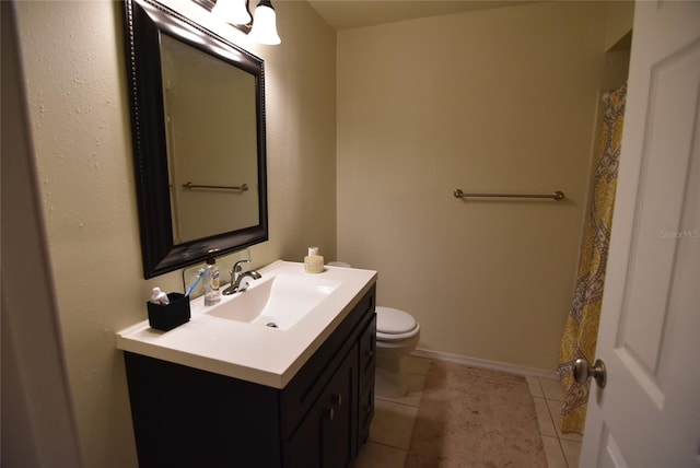 full bathroom featuring tile patterned flooring, vanity, baseboards, and toilet