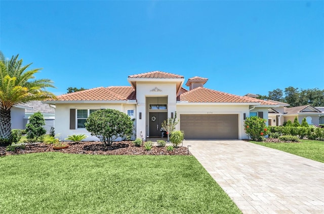 2172 Sherbrook Ave, Davenport, FL 33837 - mediterranean / spanish house with an attached garage, stucco siding, a tile roof, and a front yard