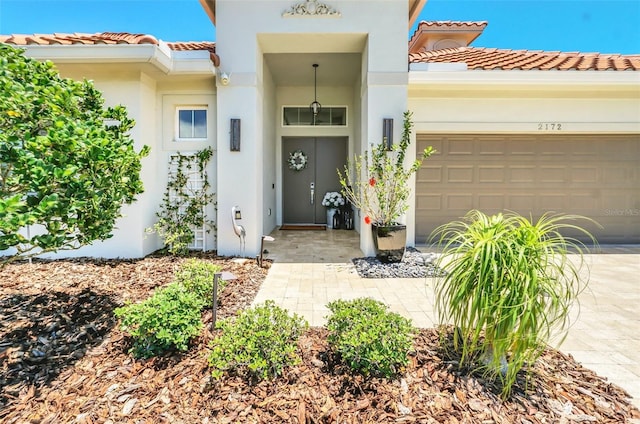 2172 Sherbrook Ave, Davenport, FL 33837 - entrance to property with a garage, stucco siding, concrete driveway, and a tile roof