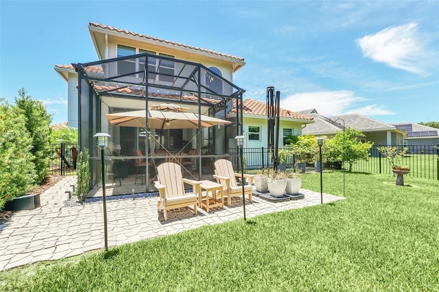 2172 Sherbrook Ave, Davenport, FL 33837 - rear view of house featuring a yard, a patio area, a tile roof, fence, and glass enclosure