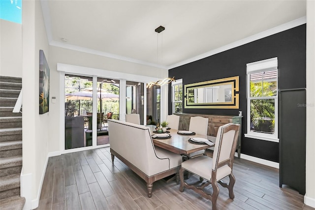 2172 Sherbrook Ave, Davenport, FL 33837 - dining space featuring a healthy amount of sunlight, wood finish floors, and stairs