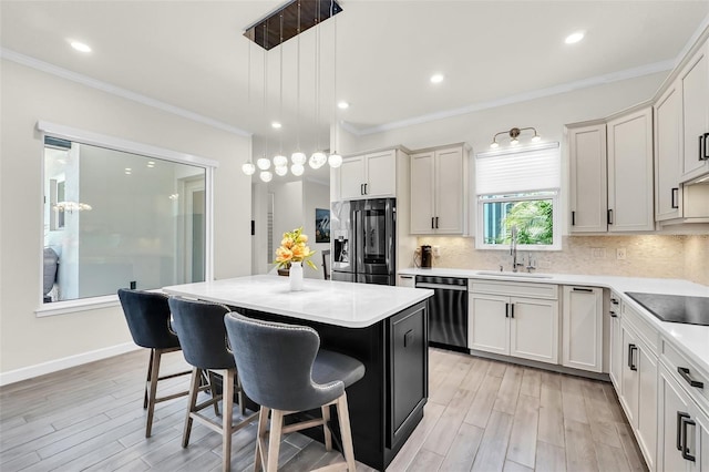 2172 Sherbrook Ave, Davenport, FL 33837 - kitchen featuring stainless steel fridge with ice dispenser, a sink, a kitchen bar, dishwashing machine, and black electric stovetop