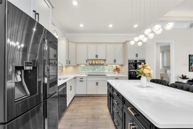2172 Sherbrook Ave, Davenport, FL 33837 - kitchen featuring light countertops, backsplash, crown molding, black appliances, and a sink