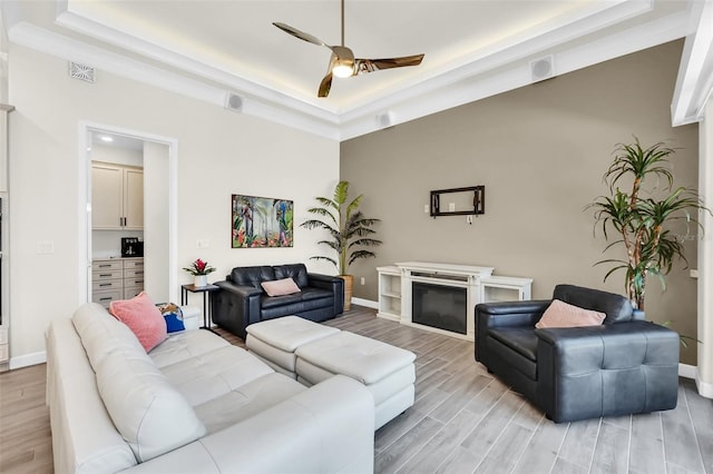 2172 Sherbrook Ave, Davenport, FL 33837 - living room with baseboards, wood finish floors, a raised ceiling, visible vents, and ceiling fan