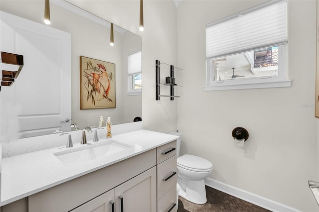 2172 Sherbrook Ave, Davenport, FL 33837 - bathroom with vanity, baseboards, and toilet