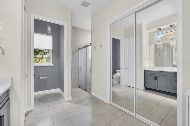 2172 Sherbrook Ave, Davenport, FL 33837 - bathroom featuring a shower stall, vanity, visible vents, toilet, and baseboards