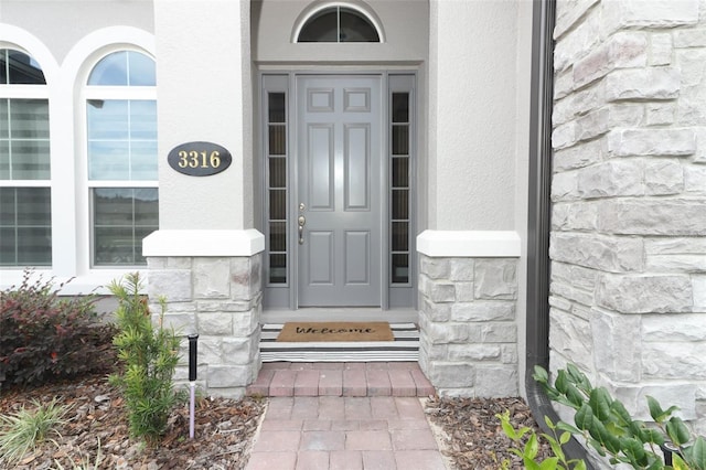 entrance to property featuring stone siding