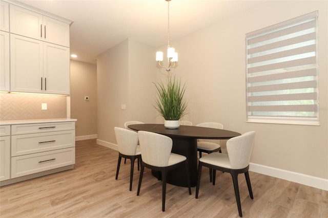 dining area with recessed lighting, light wood-style floors, baseboards, and an inviting chandelier