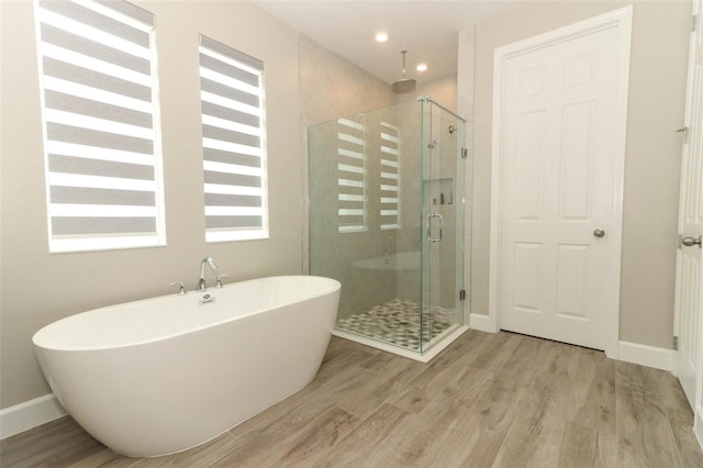 full bath featuring a stall shower and wood finished floors