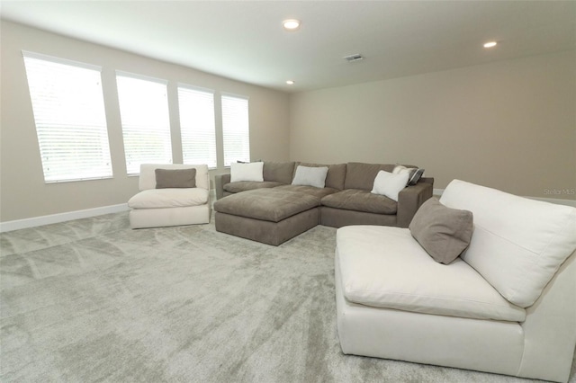 living area featuring visible vents, baseboards, recessed lighting, and carpet floors