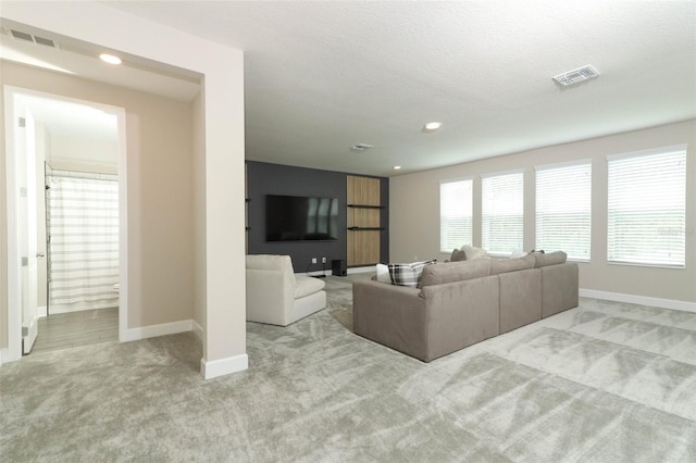 living room featuring carpet flooring, baseboards, and visible vents
