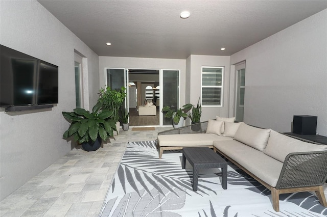 living area with recessed lighting and a textured ceiling