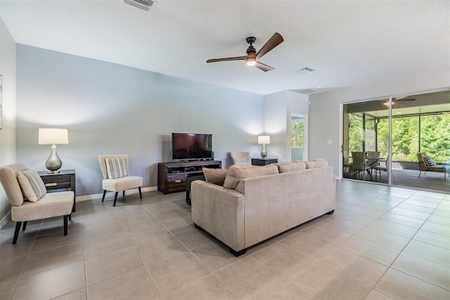 living room featuring visible vents, baseboards, a ceiling fan, and light tile patterned flooring