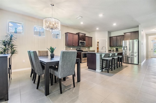 dining space with visible vents, baseboards, a chandelier, recessed lighting, and light tile patterned flooring