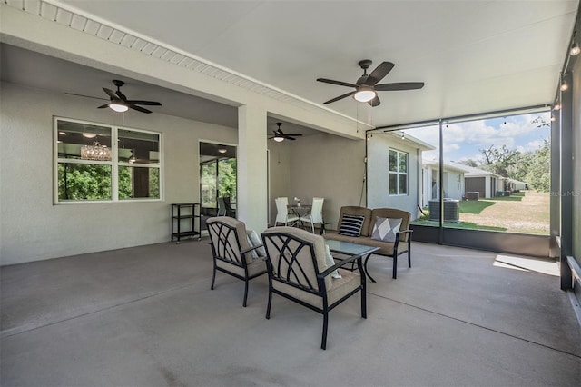 sunroom / solarium with a wealth of natural light and a ceiling fan