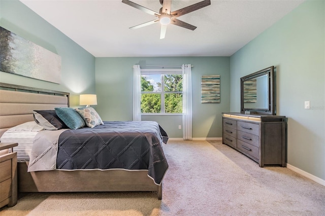carpeted bedroom with baseboards and a ceiling fan