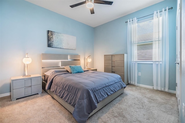 carpeted bedroom with baseboards and a ceiling fan