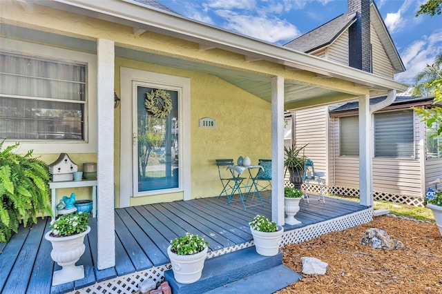1110 Virginia Ave, Saint Cloud, FL 34769 - doorway to property with a chimney, covered porch, and stucco siding