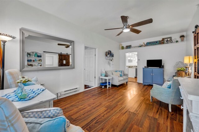 1110 Virginia Ave, Saint Cloud, FL 34769 - living area with a barn door, a baseboard heating unit, wood finished floors, and ceiling fan