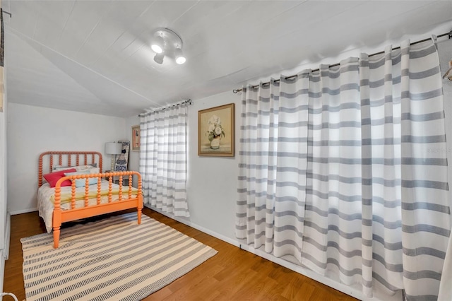 1110 Virginia Ave, Saint Cloud, FL 34769 - bedroom with wood finished floors, baseboards, and lofted ceiling