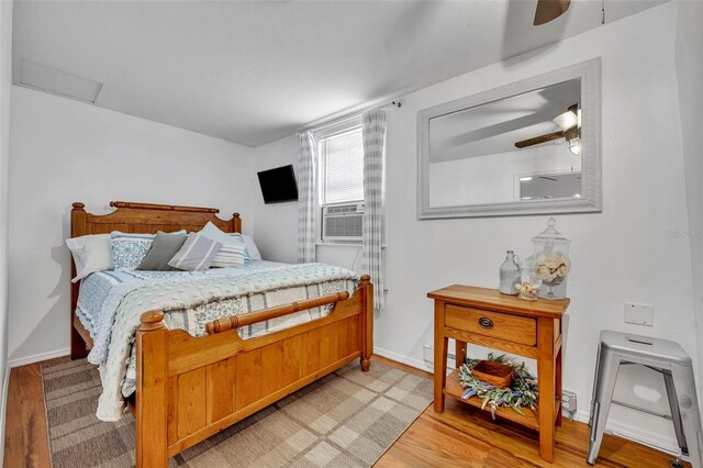 1110 Virginia Ave, Saint Cloud, FL 34769 - bedroom featuring baseboards, light wood finished floors, cooling unit, and attic access