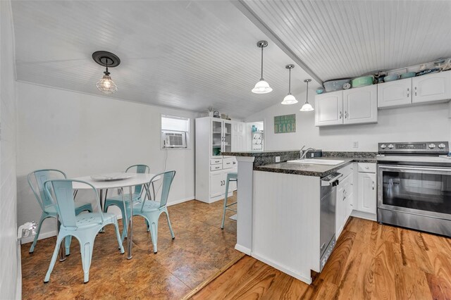 1110 Virginia Ave, Saint Cloud, FL 34769 - kitchen featuring white cabinets, a sink, a kitchen breakfast bar, a peninsula, and stainless steel appliances