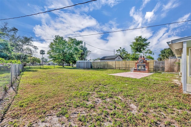 1110 Virginia Ave, Saint Cloud, FL 34769 - view of yard featuring a patio, a fenced backyard, and an outdoor fireplace