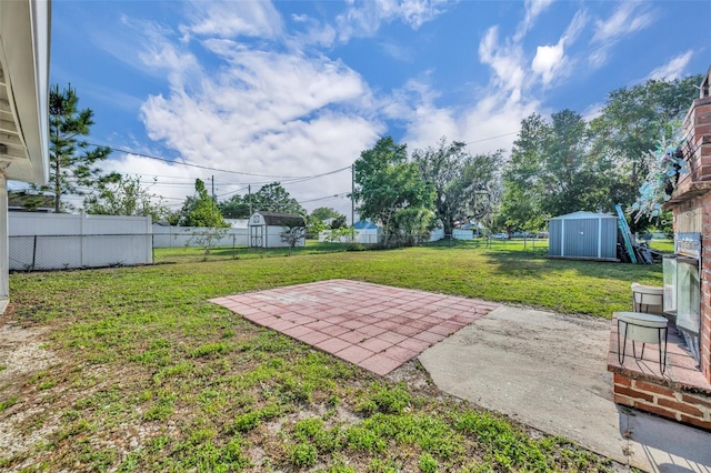1110 Virginia Ave, Saint Cloud, FL 34769 - view of yard with a patio area, a fenced backyard, a shed, and an outbuilding
