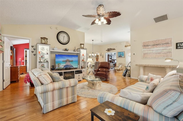 433 Arcadia Lakes Dr, The Villages, FL 32162 - living area featuring visible vents, a textured ceiling, light wood finished floors, ceiling fan with notable chandelier, and lofted ceiling