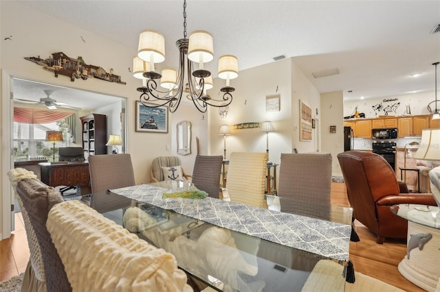 433 Arcadia Lakes Dr, The Villages, FL 32162 - dining space featuring light wood finished floors, visible vents, and ceiling fan with notable chandelier