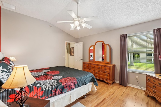 433 Arcadia Lakes Dr, The Villages, FL 32162 - bedroom featuring baseboards, vaulted ceiling, a textured ceiling, ceiling fan, and light wood finished floors