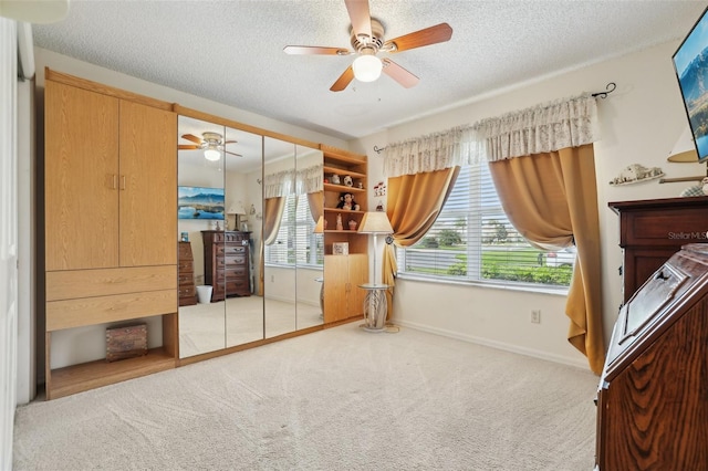 433 Arcadia Lakes Dr, The Villages, FL 32162 - carpeted bedroom featuring a closet, baseboards, a ceiling fan, and a textured ceiling