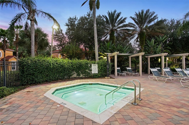8404 Secret Key Cv, Kissimmee, FL 34747 - pool at dusk featuring a hot tub, a patio, fence, and a pergola