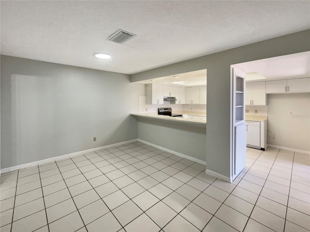 kitchen with stainless steel electric range oven, light countertops, white cabinets, under cabinet range hood, and visible vents