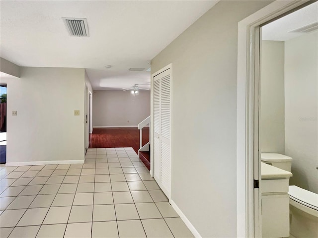 interior space featuring light tile patterned flooring, baseboards, and visible vents