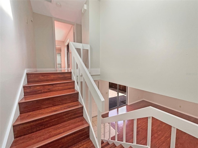 stairway with wood finished floors