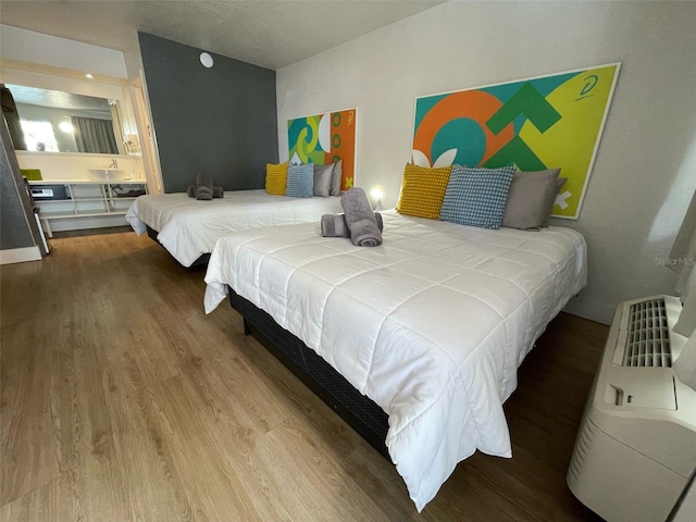 bedroom featuring wood finished floors